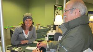 Business Manager Mike Bauer signs the transfer slip to pay off the seminary debt
